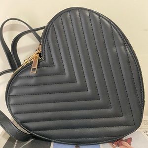 Small heart shaped black backpack